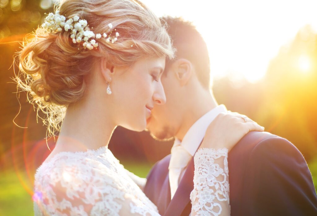 Wedding Couple, backlit by sunset-light coming through trees.